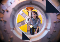 Scientist inspects particle accelerator