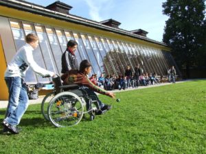 Child in wheelchair playing with peers