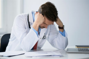 Overworked doctor doing paperwork
