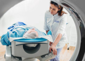 friendly doctor talking to patient . CT Scan in hospital